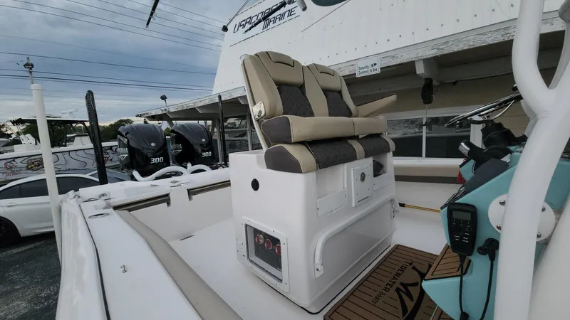 Slide: The Image of 2024 Tidewater 2700 Carolina Bay boat interior with dual seats and control panel. - 35