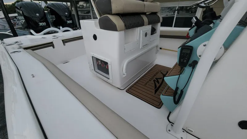 Slide: The Image of 2024 Tidewater 2700 Carolina Bay boat interior with seating and control panel. - 36