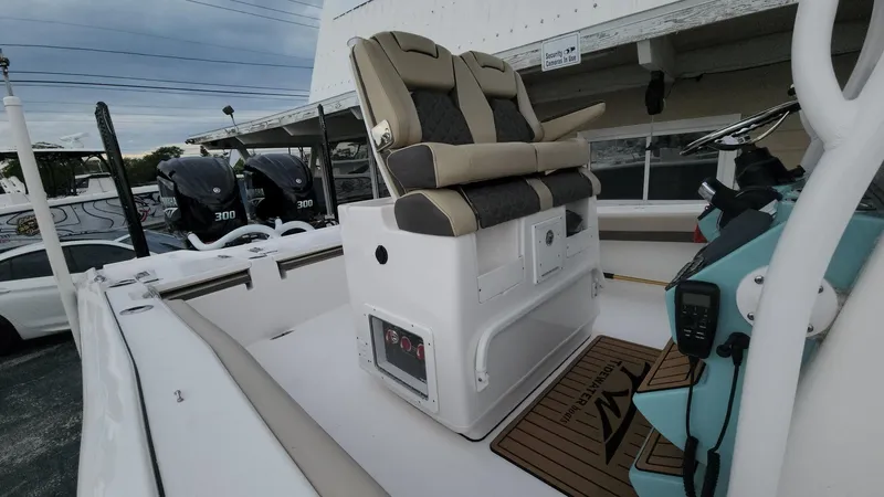 Slide: The Image of 2024 Tidewater 2700 Carolina Bay boat interior with dual seats and control panel. - 37
