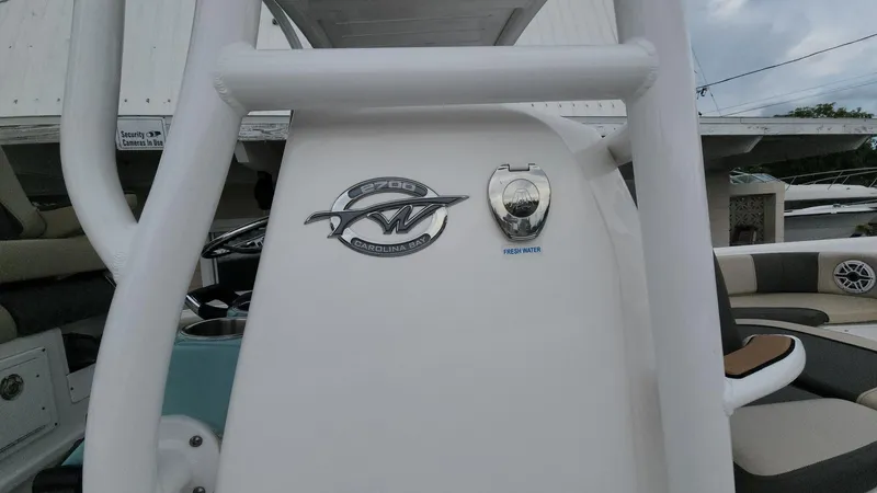 Slide: The Image of 2024 Tidewater 2700 Carolina Bay boat console with logo and fresh water access. - 39