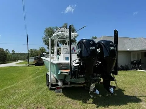Slide: The Image of 2024 Tidewater 2700 Carolina Bay boat with dual engines on a trailer. - 4