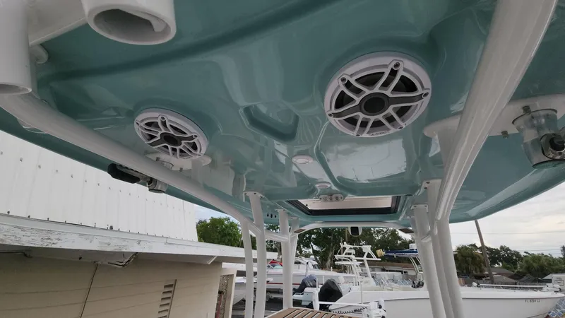 Slide: The Image of 2024 Tidewater 2700 Carolina Bay boat with speakers and rod holders on the T-top. - 44