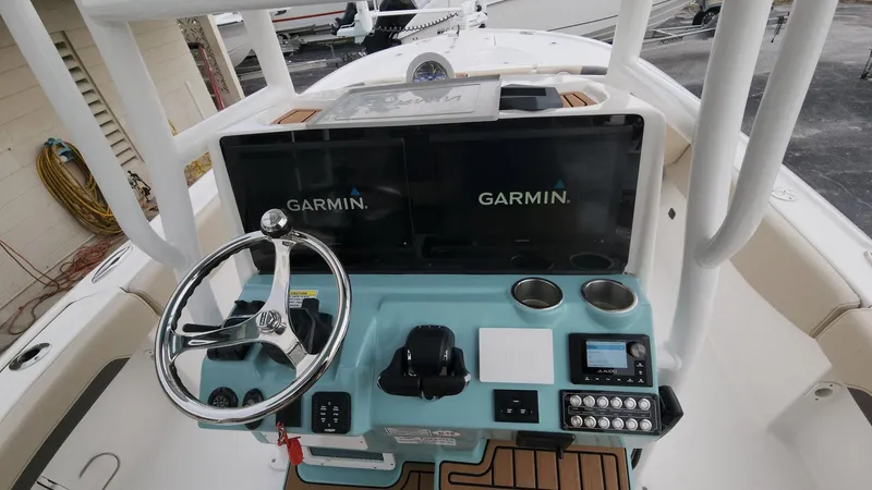 Slide: The Image of 2024 Tidewater 2700 Carolina Bay helm with Garmin displays and modern controls. - 46