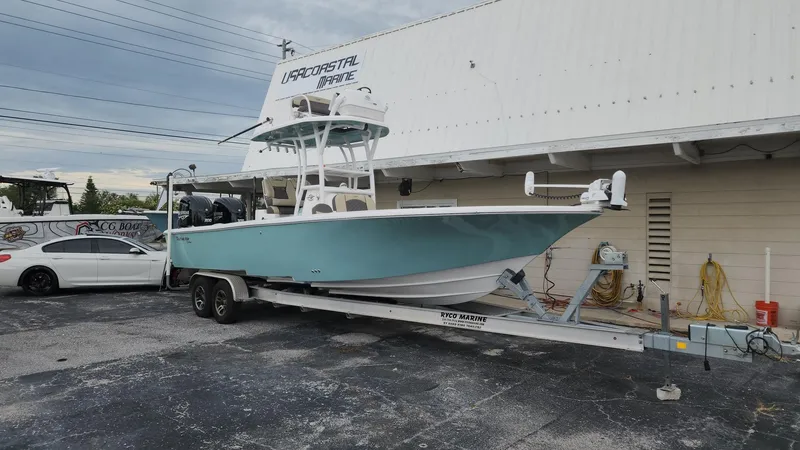 Slide: The Image of 2024 Tidewater 2700 Carolina Bay boat on trailer outside marine shop. - 48