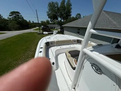 Slide: The Image of 2024 Tidewater 2700 Carolina Bay boat, white exterior, parked in residential area. - 7