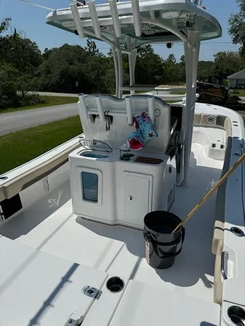 Slide: The Image of 2024 Tidewater 2700 Carolina Bay boat interior with fishing gear and storage compartments. - 8