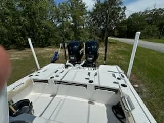 Slide: The Image of 2024 Tidewater 2700 Carolina Bay boat with dual engines, parked outdoors. - 9