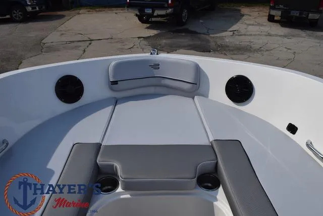 Slide: The Image of 2025 Bayliner VR5 Bowrider Outboard interior with seating and speakers, Thayer's Marine logo. - 12