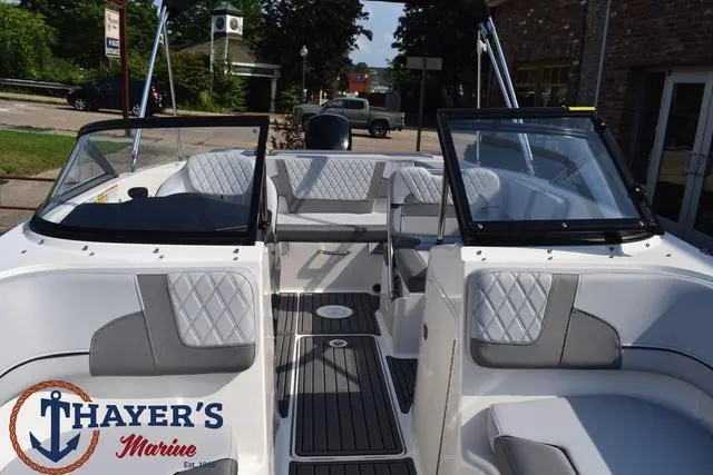 Slide: The Image of 2025 Bayliner VR5 Bowrider boat interior with gray seating, showcased at Thayer's Marine. - 16