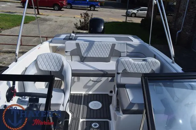 Slide: The Image of 2025 Bayliner VR5 Bowrider Outboard interior with seating and steering wheel. - 21