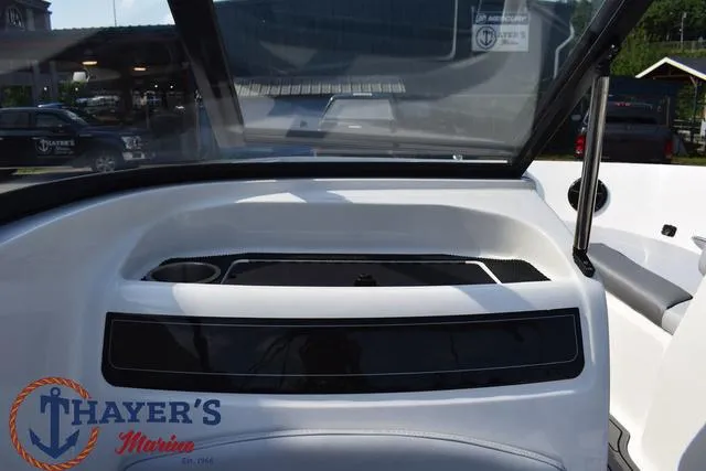 Slide: The Image of 2025 Bayliner VR5 Bowrider Outboard interior with windshield and dashboard view. - 24