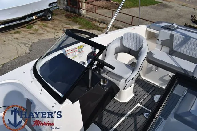 Slide: The Image of 2025 Bayliner VR5 Bowrider Outboard interior with steering wheel and seating, Thayer's Marine logo. - 26
