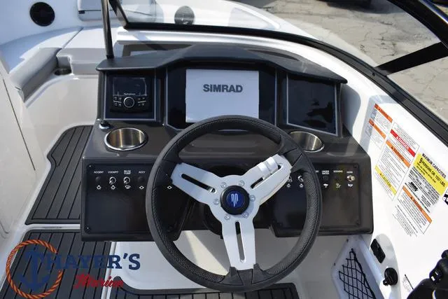 Slide: The Image of 2025 Bayliner VR5 Bowrider dashboard with Simrad display and steering wheel. - 28