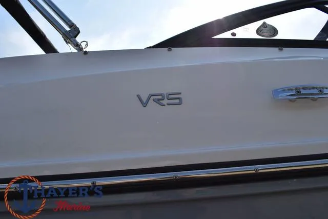 Slide: The Image of 2025 Bayliner VR5 Bowrider Outboard boat side view with logo and railing. - 3
