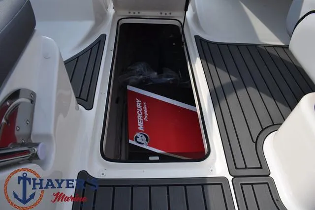 Slide: The Image of 2025 Bayliner VR5 Bowrider interior with Mercury storage compartment, Thayer Marine logo visible. - 33