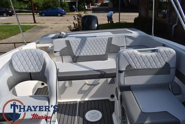 Slide: The Image of 2025 Bayliner VR5 Bowrider interior with gray seating and Thayer's Marine logo. - 34