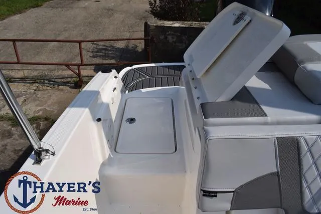 Slide: The Image of 2025 Bayliner VR5 Bowrider Outboard boat interior with storage compartment, Thayer's Marine logo. - 39