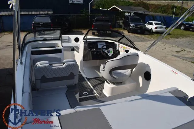 Slide: The Image of 2025 Bayliner VR5 Bowrider Outboard interior with modern seating and steering console. - 44