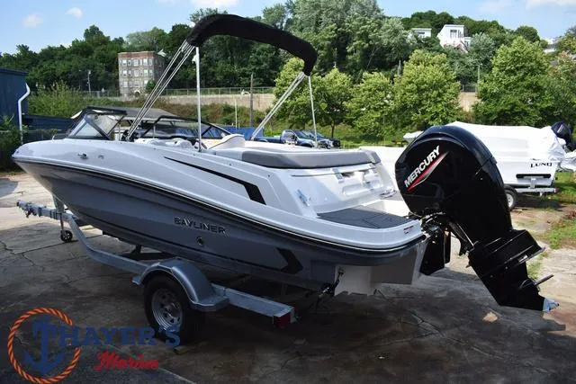 Slide: The Image of 2025 Bayliner VR5 Bowrider Outboard boat on trailer, parked outdoors. - 7