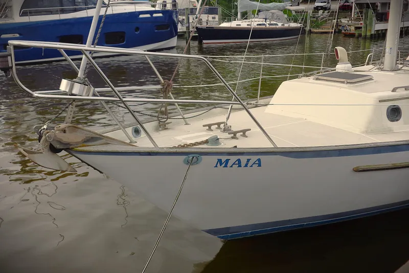 Slide: The Image of 1983 Pacific Seacraft Crealock 37 sailboat docked, named "MAIA," with visible anchor and railing. - 10