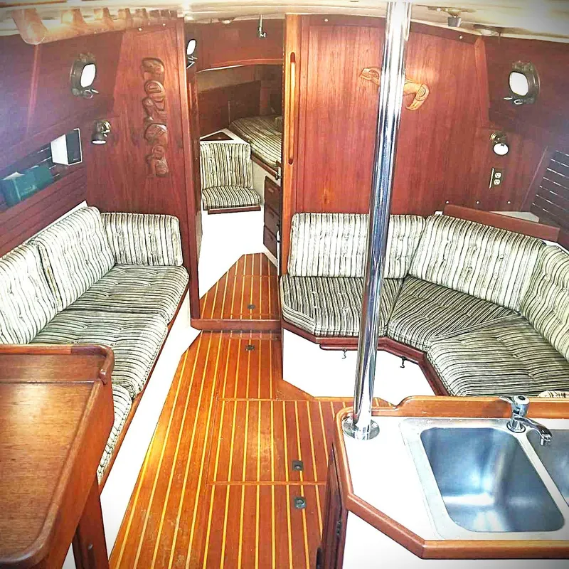 Slide: The Image of Interior of 1983 Pacific Seacraft Crealock 37 sailboat with striped seating and wood finish. - 2