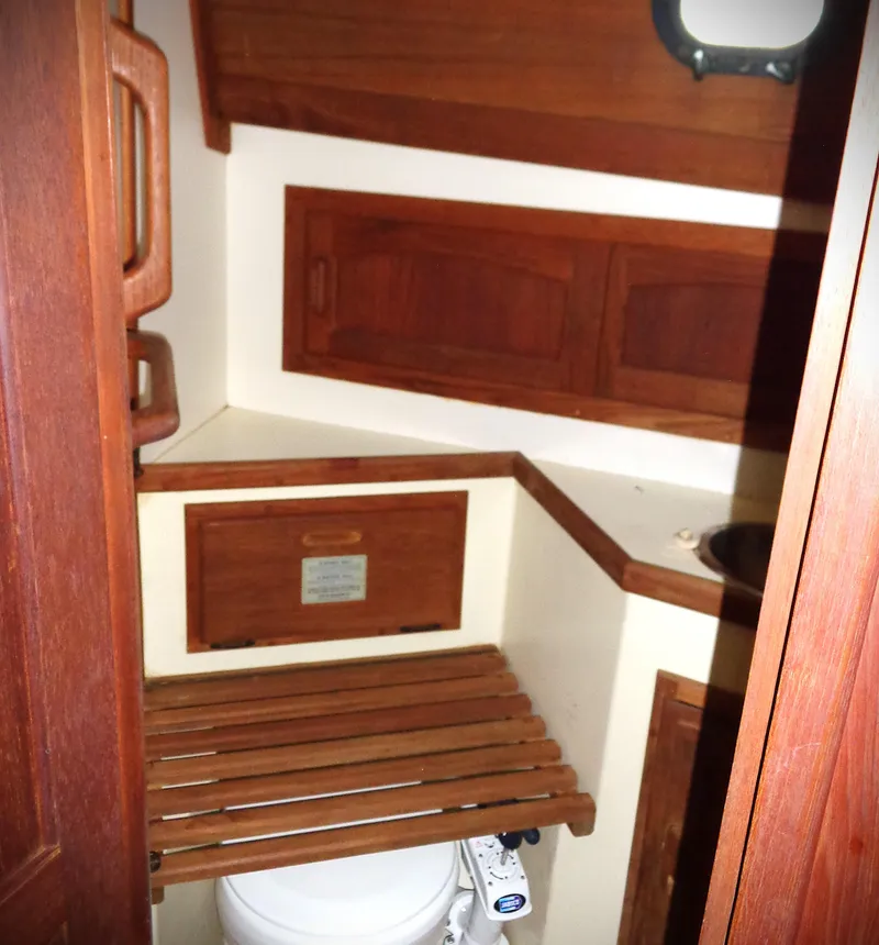 Slide: The Image of 1983 Pacific Seacraft Crealock 37 yacht bathroom with wooden cabinetry and compact design. - 5