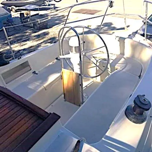 Slide: The Image of 1983 Pacific Seacraft Crealock 37 sailboat cockpit with steering wheel and seating. - 8