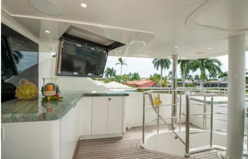 Slide: The Image of Luxurious yacht deck with TV, bar, and spiral staircase, Horizon 136 Premier 2010 model. - 11