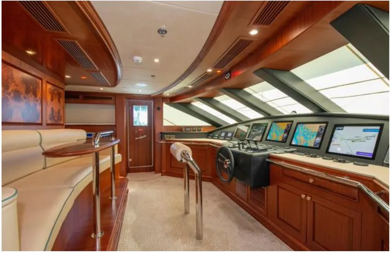 Slide: The Image of Luxurious 2010 Horizon 136 Premier yacht interior with navigation equipment and elegant wood finishes. - 17