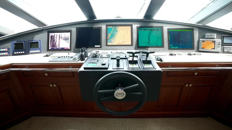 Slide: The Image of Control panel of 2010 Horizon 136 Premier yacht with multiple screens and steering wheel. - 18