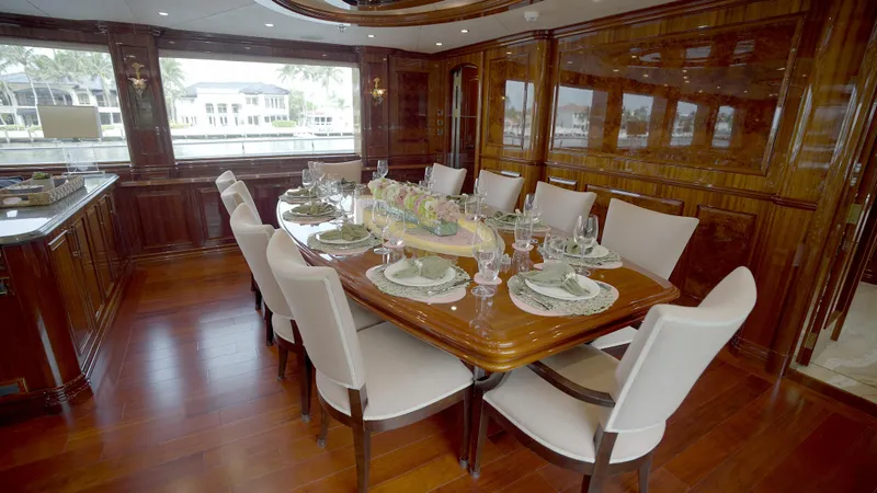 Slide: The Image of Luxurious dining area on 2010 Horizon 136 Premier yacht with elegant wood finish. - 25