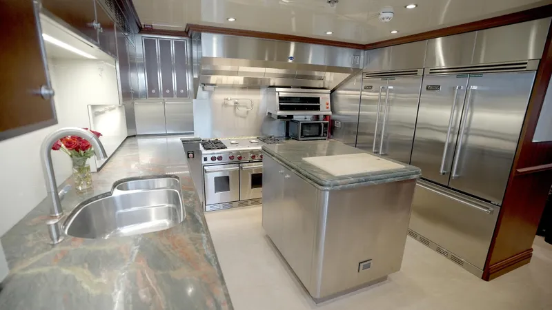 Slide: The Image of Luxurious yacht kitchen with stainless steel appliances, marble countertops, and modern design. Horizon 136 Premier 2010. - 26