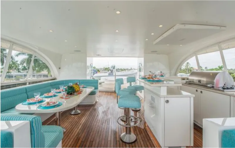 Slide: The Image of Luxurious Horizon 136 Premier yacht interior with elegant dining area, turquoise seating, and modern kitchen. - 3