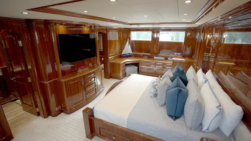 Slide: The Image of Luxurious 2010 Horizon 136 Premier yacht bedroom with elegant wood paneling and plush bedding. - 30