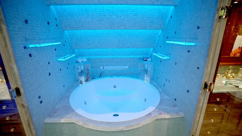 Slide: The Image of Luxurious bathroom with blue-lit jacuzzi in 2010 Horizon 136 Premier yacht. - 32