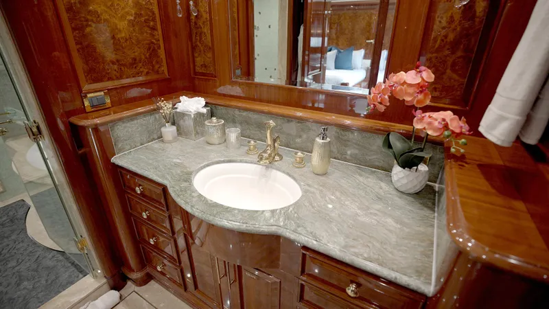 Slide: The Image of Luxurious yacht bathroom with marble countertop, elegant fixtures, and floral decor on Horizon 136 Premier. - 33