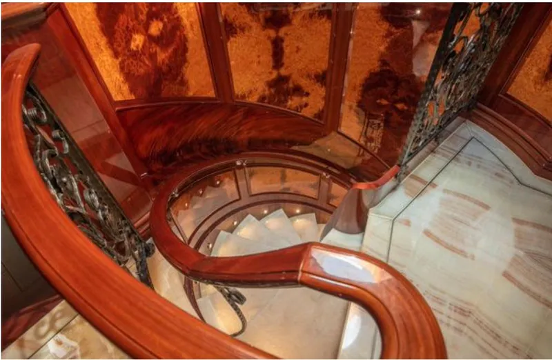 Slide: The Image of Luxurious spiral staircase with elegant wood and metal details on Horizon 136 Premier yacht. - 35