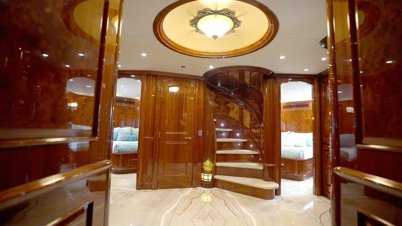 Slide: The Image of Luxurious interior of 2010 Horizon 136 Premier yacht with elegant wood finishes and spiral staircase. - 38