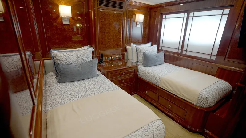 Slide: The Image of Luxurious twin bedroom in 2010 Horizon 136 Premier yacht, featuring elegant wood paneling. - 44