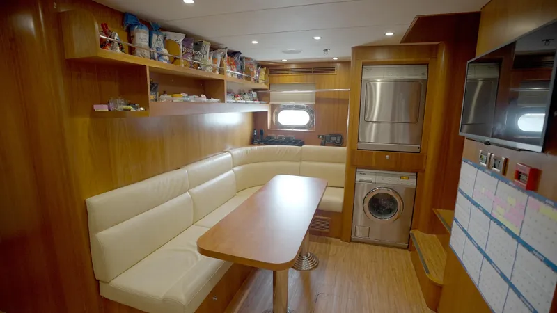 Slide: The Image of Luxurious yacht interior with dining area, modern appliances, and wooden finish, Horizon 136 Premier 2010. - 46