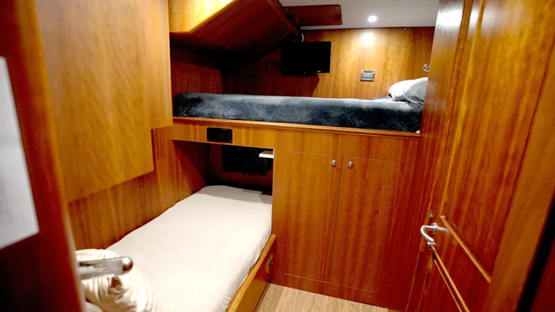 Slide: The Image of Cozy wooden cabin interior with bunk beds on a 2010 Horizon 136 Premier yacht. - 48