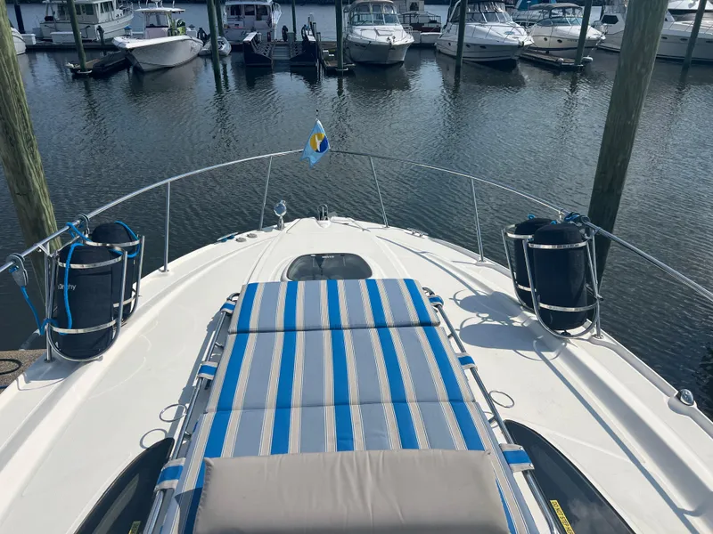 Slide: The Image of 2010 Sea Ray 350 Sundancer yacht with striped deck, docked at marina. - 10