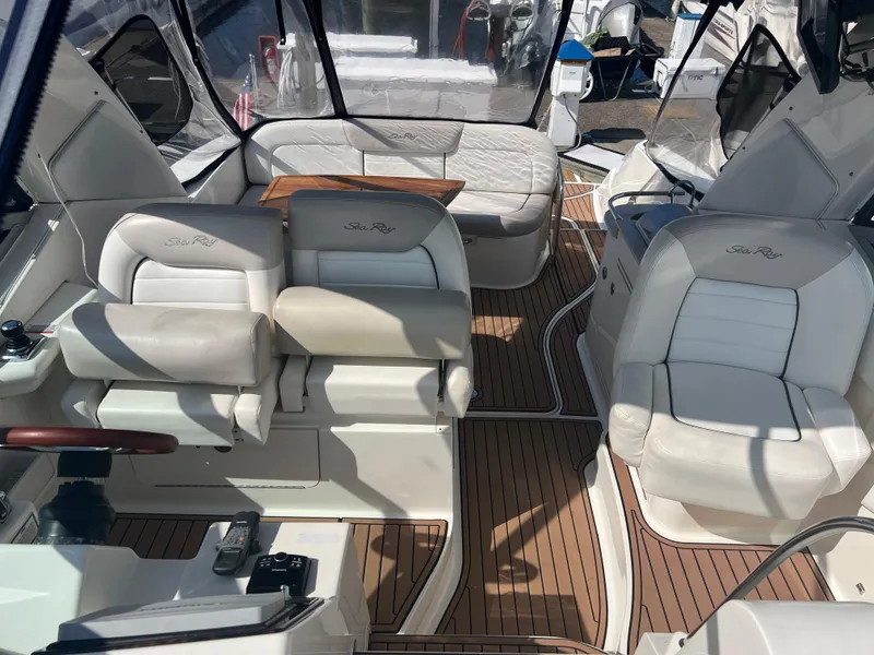 Slide: The Image of 2010 Sea Ray 350 Sundancer interior with white seating and wood flooring. - 11