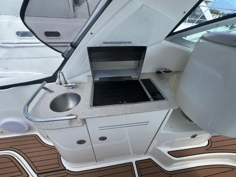 Slide: The Image of 2010 Sea Ray 350 Sundancer boat kitchenette with grill and sink. - 16