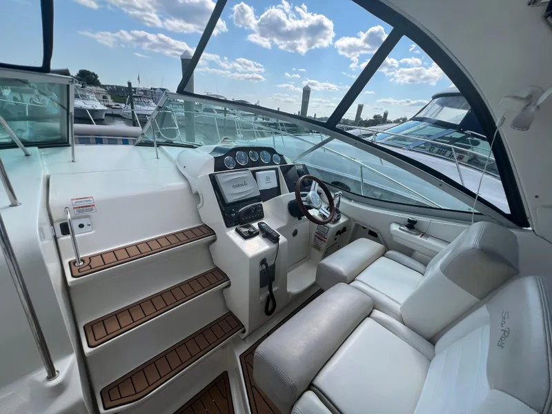 Slide: The Image of 2010 Sea Ray 350 Sundancer cockpit with modern controls and comfortable seating. - 19