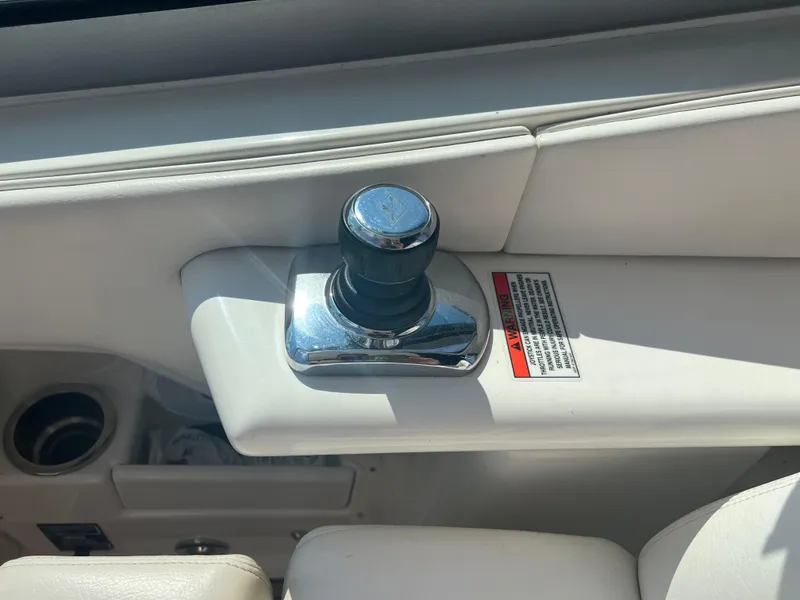 Slide: The Image of 2010 Sea Ray 350 Sundancer boat control knob on white interior panel. - 21