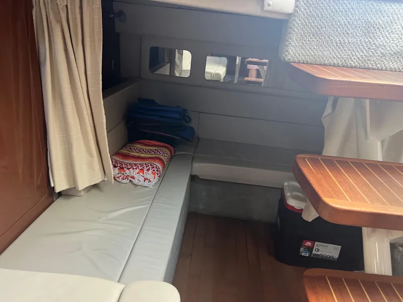 Slide: The Image of Interior cabin of 2010 Sea Ray 350 Sundancer with seating and wooden accents. - 32