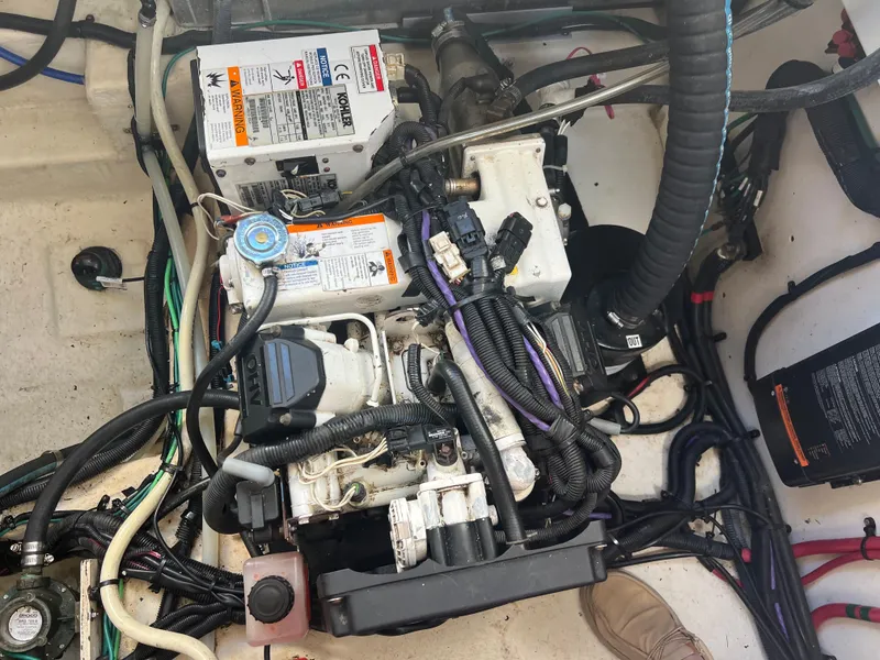 Slide: The Image of Engine compartment of a 2010 Sea Ray 350 Sundancer boat, showing wiring and components. - 36