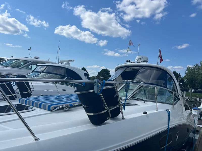 Slide: The Image of Sea Ray 350 Sundancer 2010 yacht docked under a blue sky with clouds. - 8