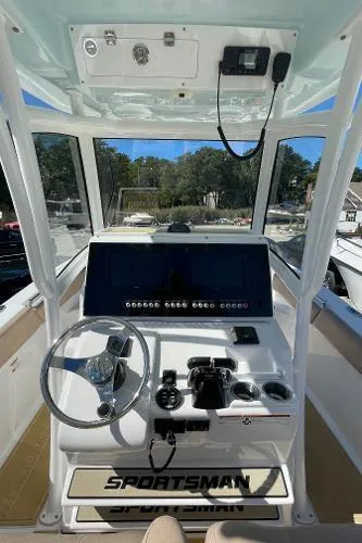 Slide: The Image of 2019 Sportsman 282 boat cockpit with steering wheel and control panel. - 14